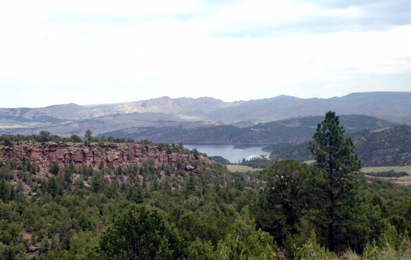 Flaming Gorge with rocky hillsides and mountains as landscape.