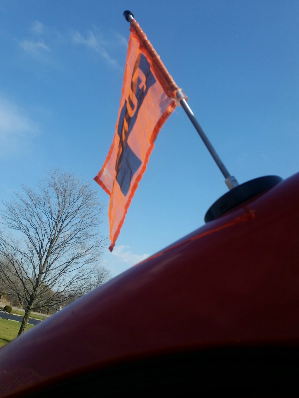 Orange flag flying from the top of an RV.