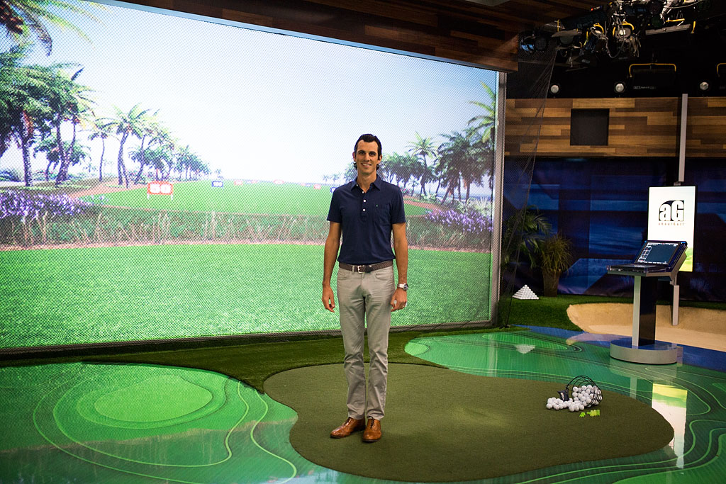 Jordan in front of large screen in Golf Studio two.