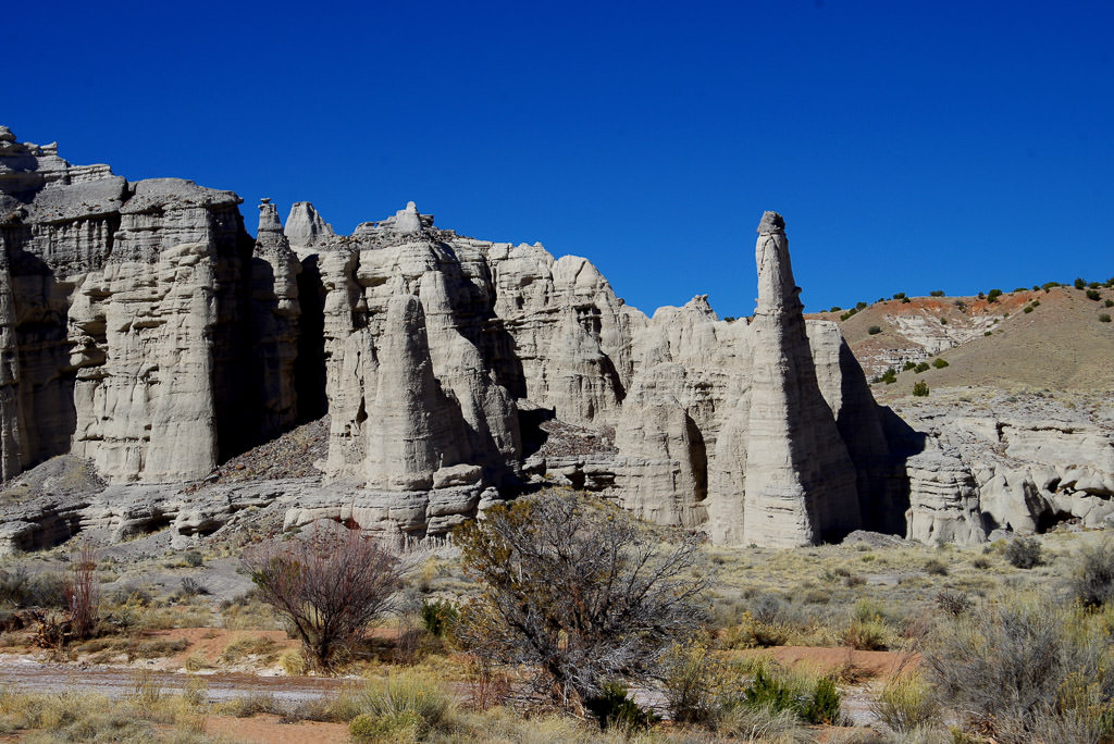 Tall rock formations with dry landscape below.