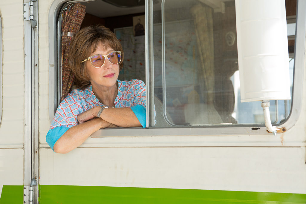 Woman with head out passenger side window onset of movie