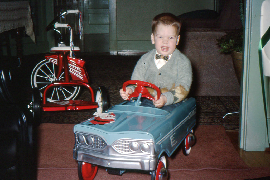 Young Rodney pretending to drive a toy car