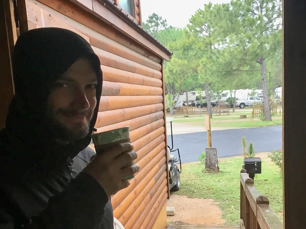 Jeremy drinking coffee in one of the cabins at Jellystone
