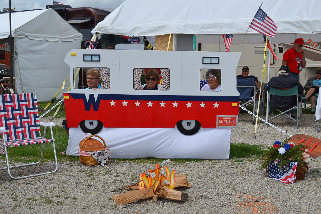 Rally attendees posing with small Winnebago cut out